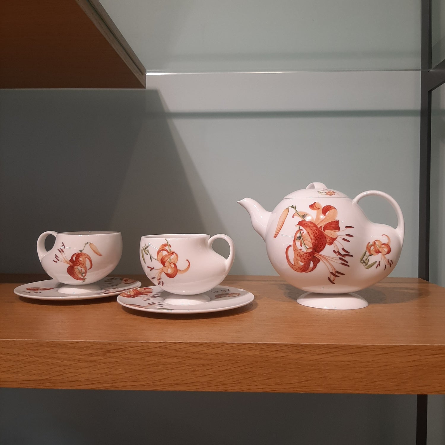 青春 In Bloom porcelain tea set photographed against a decorative interior backdrop, showcasing floral patterns inspired by Giuseppe Castiglione