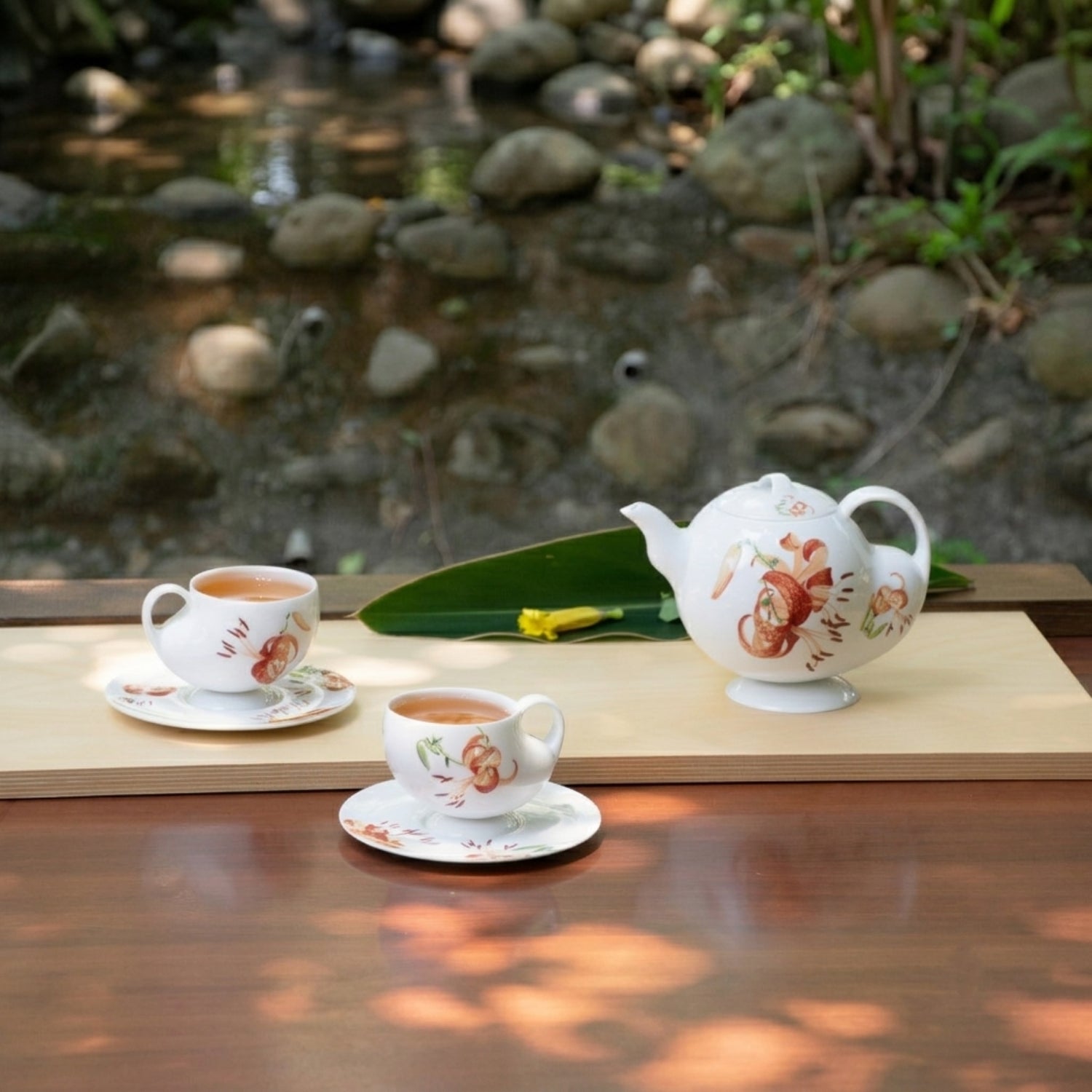 青春 In Bloom porcelain saucers featuring blooming lily artwork wrapped around the circular form, contemporary porcelain design by NewChi